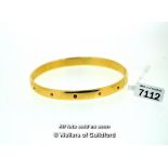 9ct yellow gold fixed bangle set with five small rubies, gross weight 33.7 grams