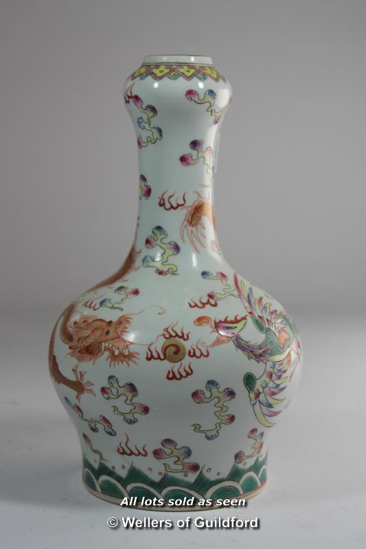 A Chinese bottle vase painted with a dragon and a phoenix, 23.5cm.