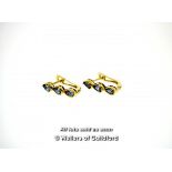 Pair of 9ct yellow gold earrings, each set with three pear shaped purple stones, gross weight 2.2