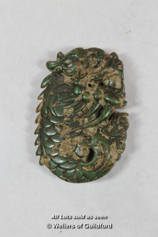 A Chinese green hardstone pendant carved as a dragon. - Image 2 of 2