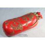 A Chinese red pottery pillow, 33cm long.