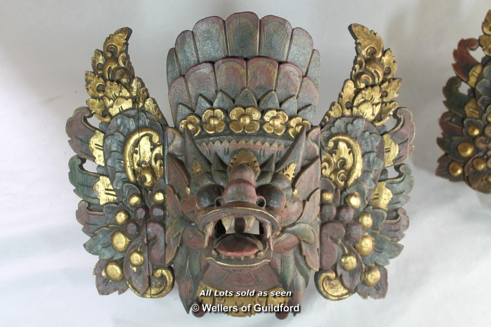 A pair of Balinese masks carved and gilded as mythical beasts. - Image 2 of 5