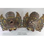 A pair of Balinese masks carved and gilded as mythical beasts.