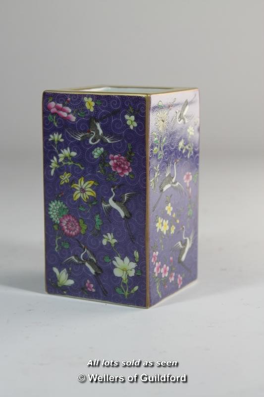 A Chinese square section brush pot painted ith flowers and cranes on a purple ground, 10cm.