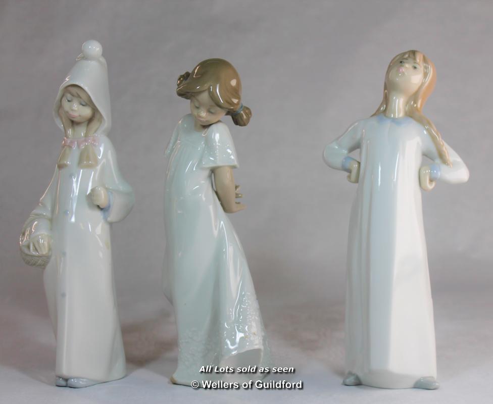 Lladro figure of girl in night clothes; two Nao figures of children (3)