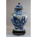 A Chinese blue and white ginger jar and cover, decorated with figures in a landscape, four character