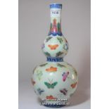 A Chinese polychrome double gourd vase decorated with butterflies on a cream ground,29cm.
