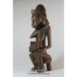 A carved wooden African fertility figure, 33cm.
