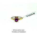Pink sapphire ring, oval cut pink sapphire rubover set in 9ct yellow gold, on a 9ct white gold band,