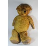 A large jointed teddy bear with golden fur, stitched nose and mouth, 78cm.