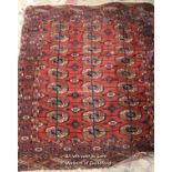 A small red Persian rug with three rows of medallions, 124 x 105cm.