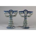 A pair of faience table ornaments modelled as ladies holding baskets, each lady double faced, 18.