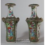 A pair of late 19th Century famille rose vases, with slender necks, lions' head lug handles,