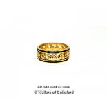 Ornate band ring, openwork band with a flower design and black enamel edges, in yellow metal stamped