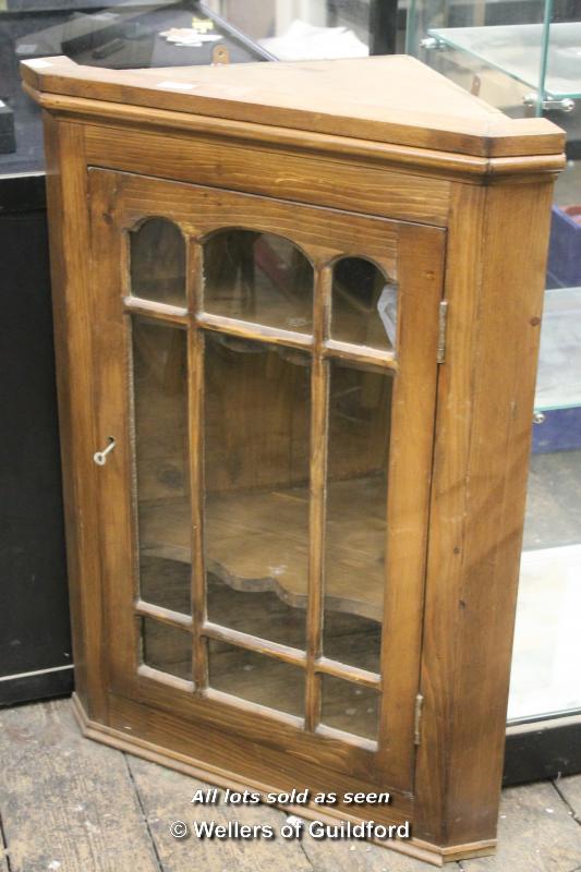 Pitch pine hanging corner cabinet with glazed door enclosing shelves, 89cm