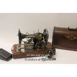 A vintage Singer sewing machine serial number P960799, with added sewing machine motor and case
