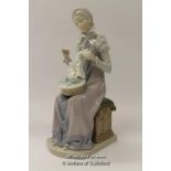 Lladro figure of a seated woman sewing, 29.5cm.