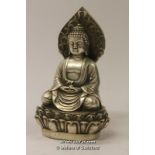 A Chinese white metal figure of Buddha seated on a lotus flower, 13cm.