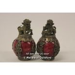 A pair of Chinese hardstone globular paperweights with white metal mounts surmounted by dogs of