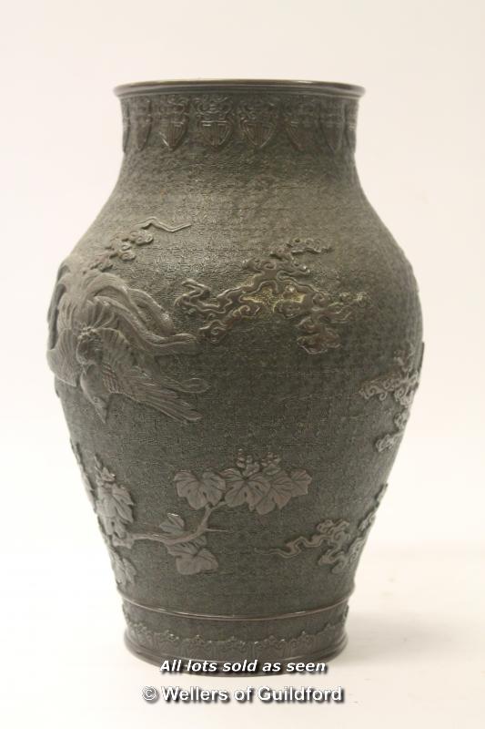 A Chinese bronze baluster vase decorated in relief with dragons, 28.5cm.