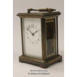 A French brass carriage clock with white enamel dial and Arabic numerals, 14cm including handle.