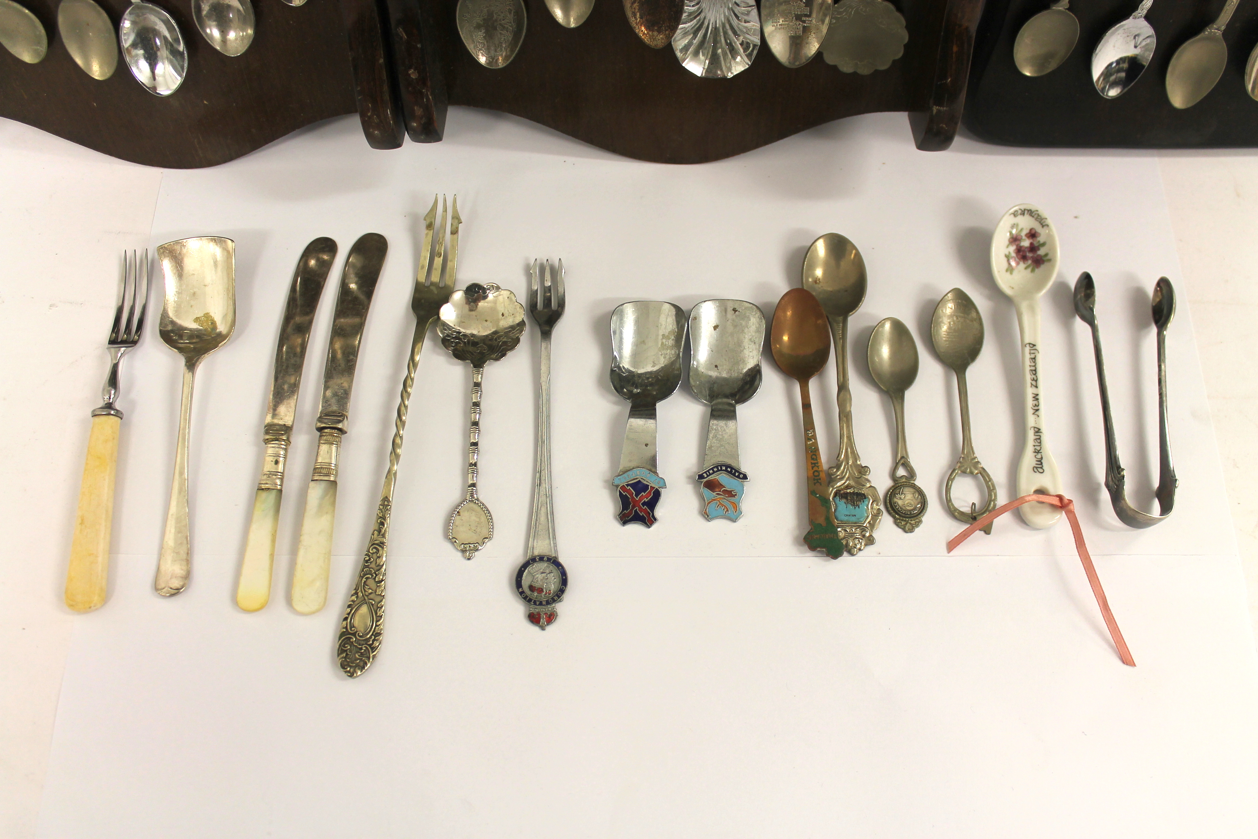 A quantity of silver plated souvenir spoons with three wooden display racks; white metal pierced - Image 5 of 7