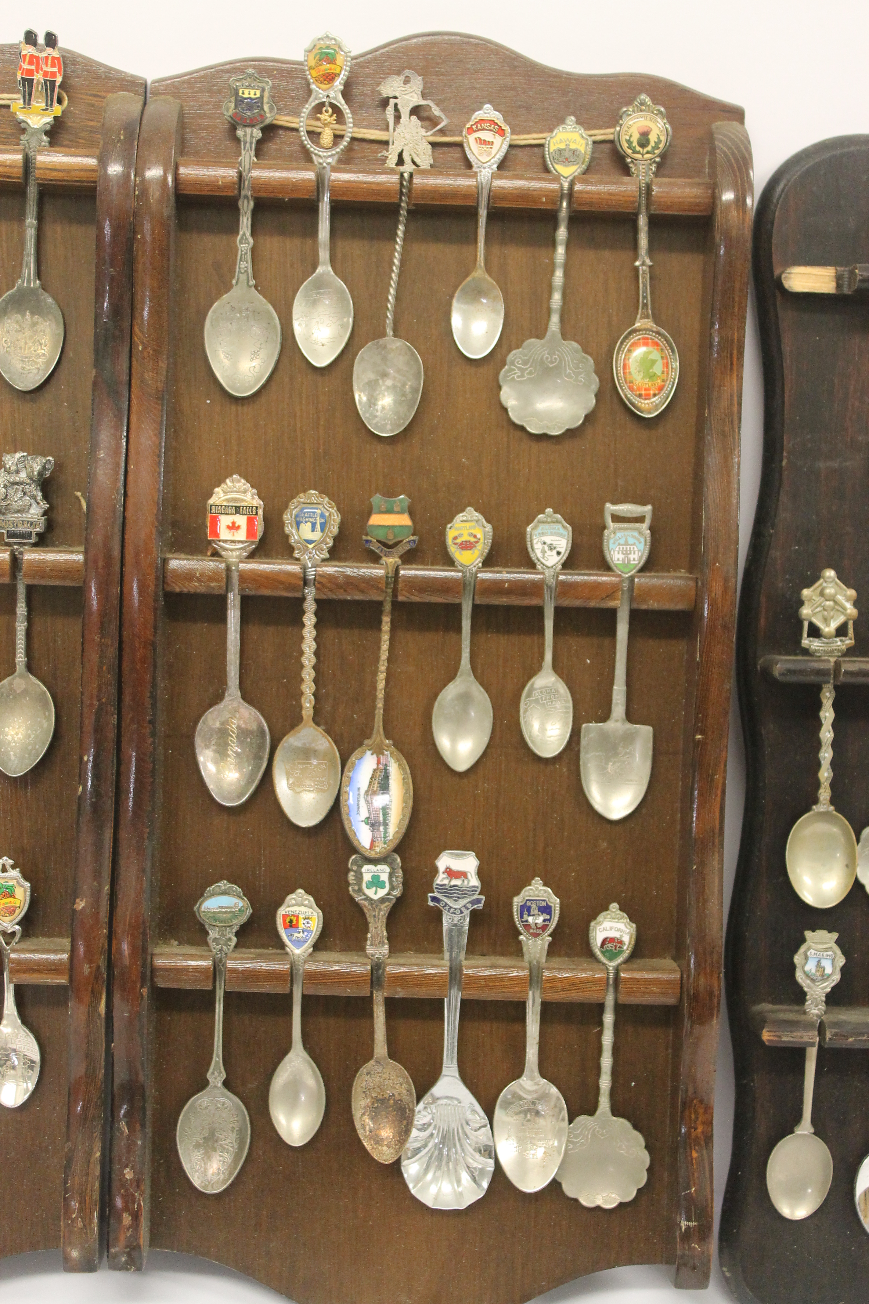 A quantity of silver plated souvenir spoons with three wooden display racks; white metal pierced - Image 3 of 7