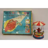 Chad Valley Give-a-Show projector, boxed; German tinplate fairground ride. (2)