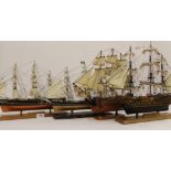 Four small model ships comprising two each of the Cutty Sark and H.M.S. Victory, one Cutty Sark with