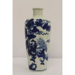 A Chinese blue and white vase decorated with figures in a garden, two rings to base, 27cm.