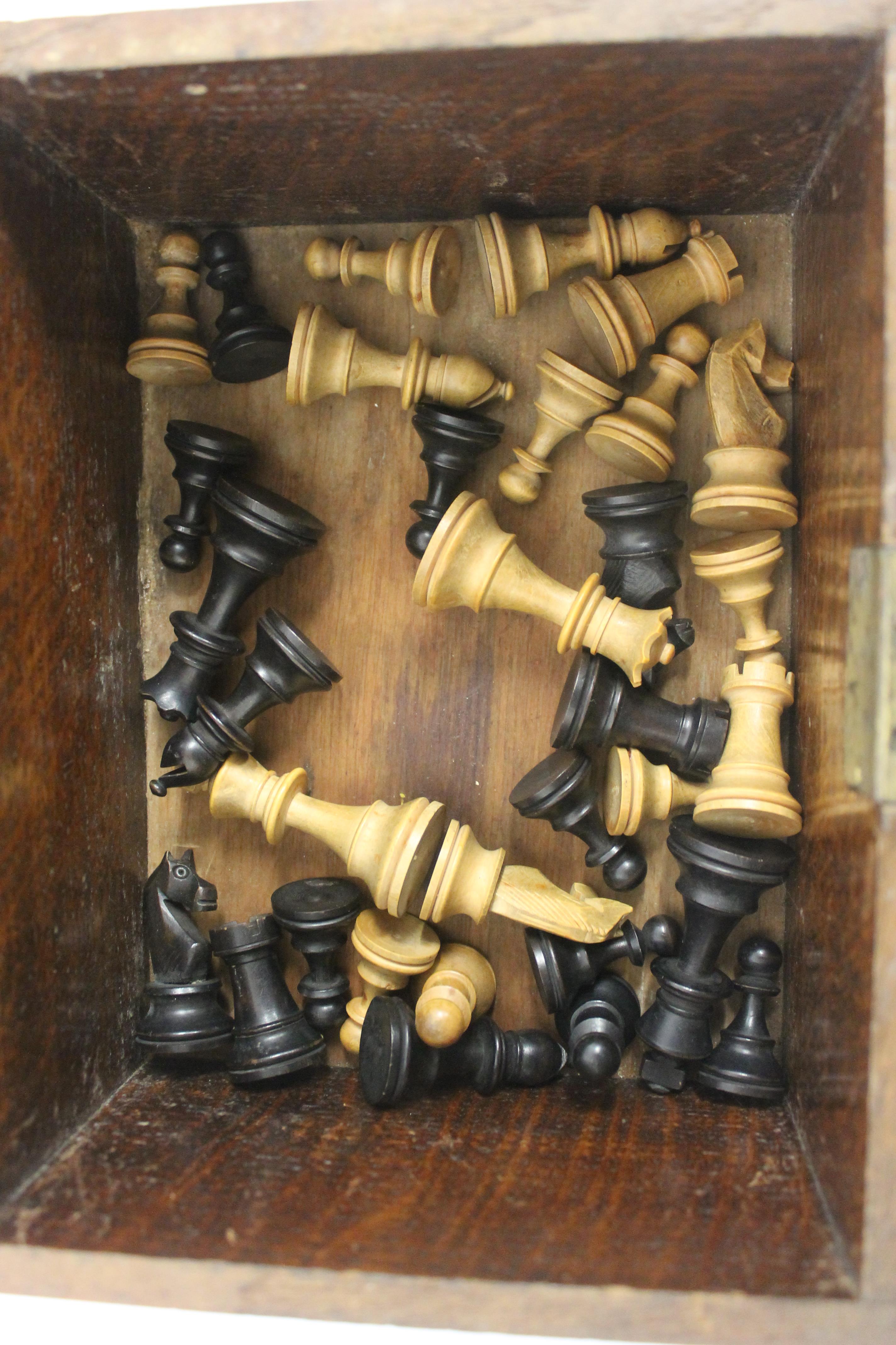 A Staunton pattern boxwood chess set, height of king 6.75cm, in old oak box, 23cm diameter. - Image 2 of 3