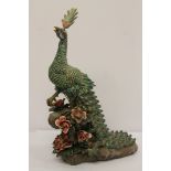 Chinese porcelain peacock with brightly coloured tail, 47cm.