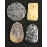 Four Chinese hardstone pendants.