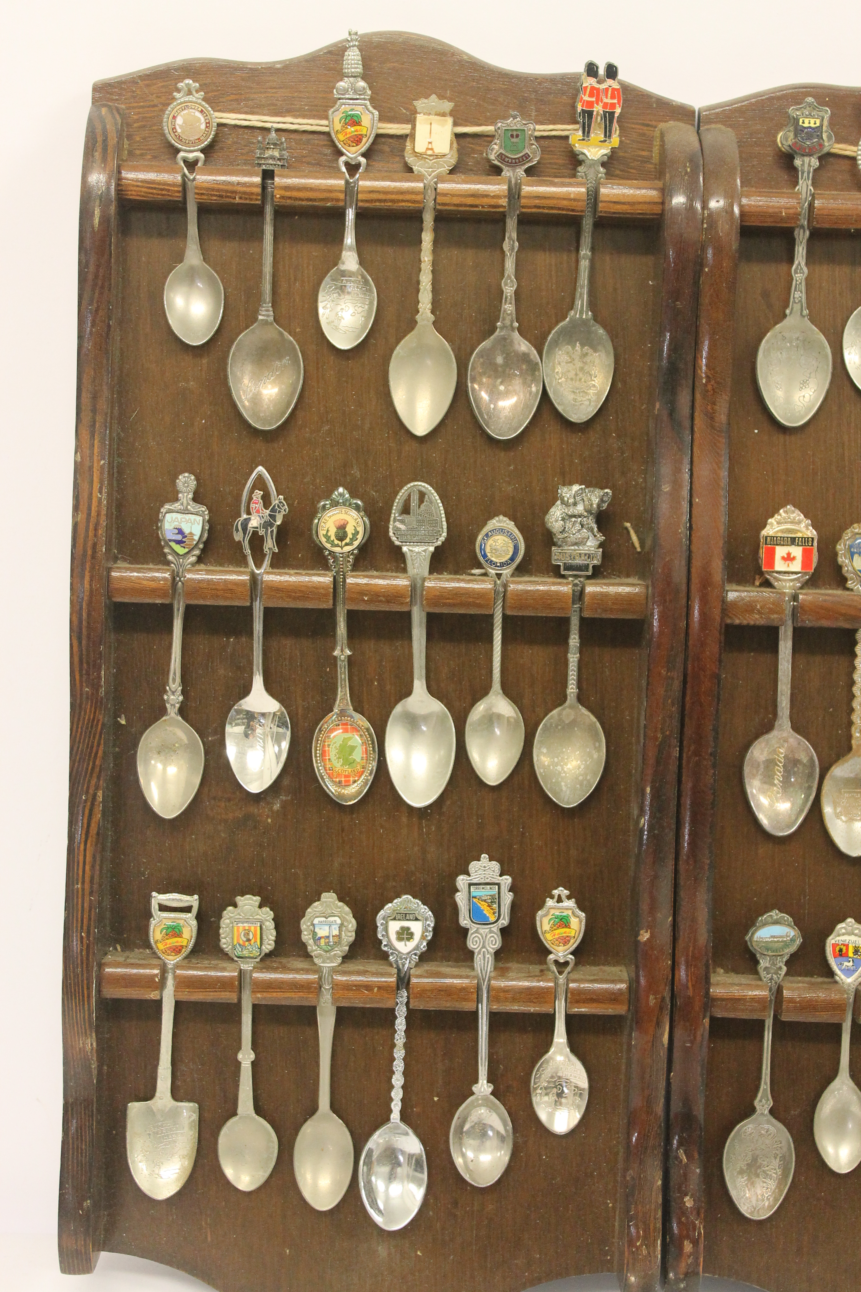 A quantity of silver plated souvenir spoons with three wooden display racks; white metal pierced - Image 2 of 7