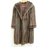 Musquash mid length fur coat.