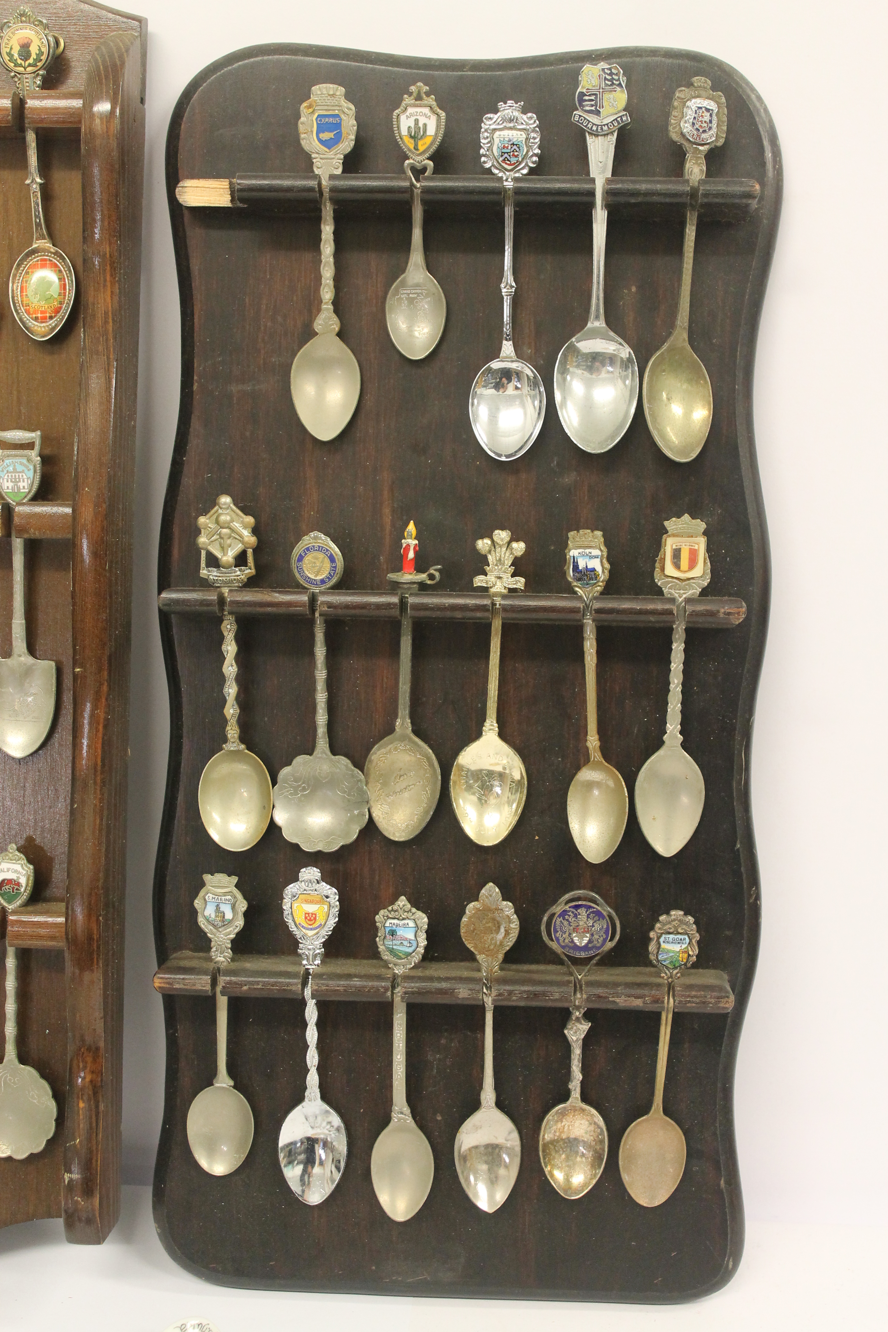 A quantity of silver plated souvenir spoons with three wooden display racks; white metal pierced - Image 4 of 7