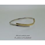 *Hinged bangle in a wavy design in silver and yellow metal stamped as 9ct, weight 7.0 grams (Lot