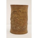 A Chinese carved bamboo brush pot carved with a dragon, 18cm. no reserve