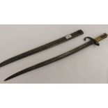 19th Century French bayonet and scabbard with ribbed brass handle, serial number P54048, length of