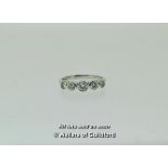 Five stone diamond ring, graduating round brilliant cut diamonds rubover set in white metal