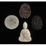 Four Chinese hardstone pendants.