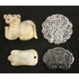 Four Chinese hardstone pendants.