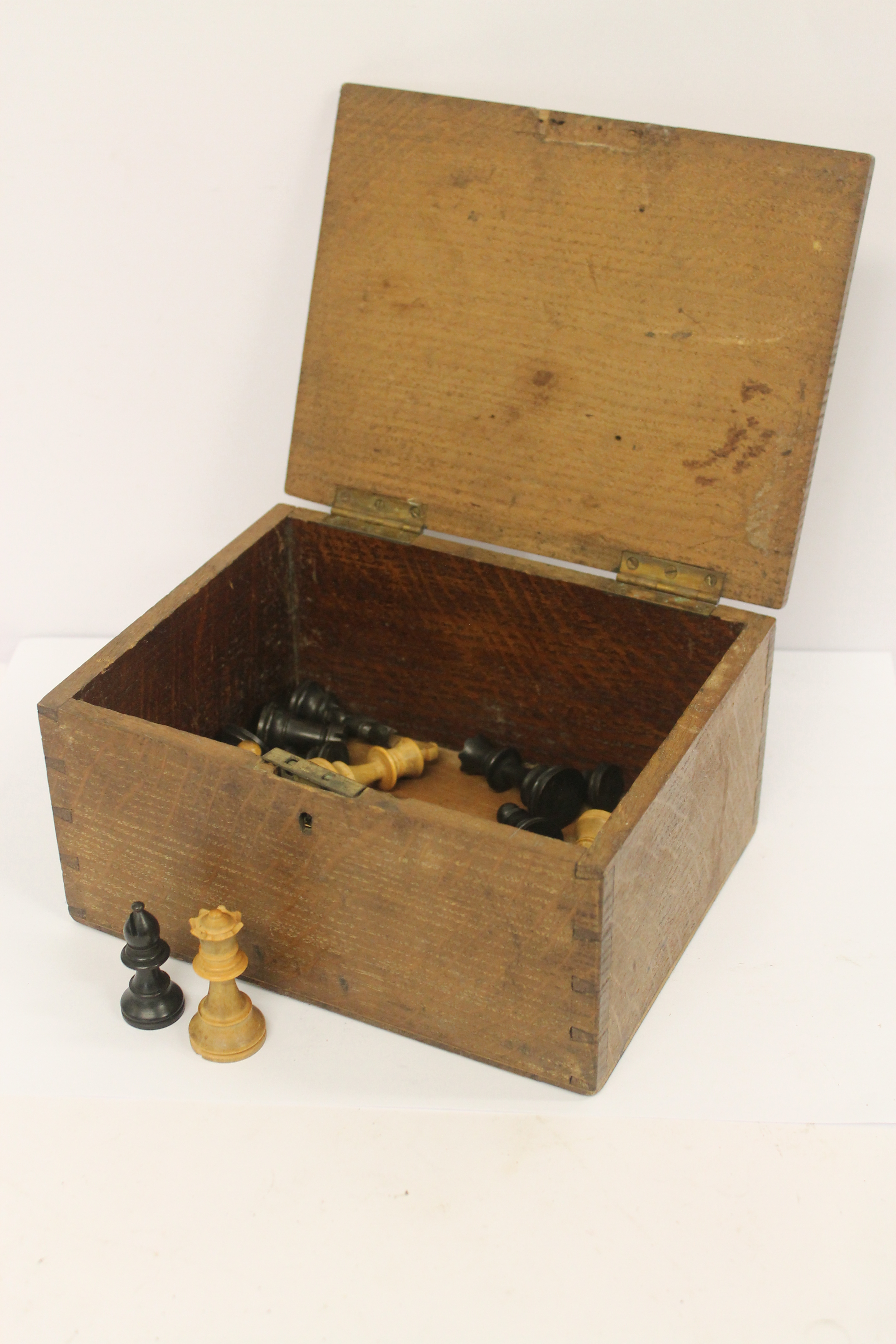 A Staunton pattern boxwood chess set, height of king 6.75cm, in old oak box, 23cm diameter.