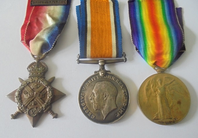 A Mons Star and Bar Trio to Private W.H. Moore, 1st Battalion, Devonshire Regiment. 1914 Star,