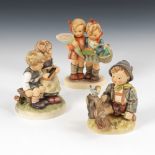 3 HUMMEL-Figuren: Kinderpaar mit Einkäufen, Kinderpaar mit Schiefertafel,Junge mit Vögelchen.Jeweils