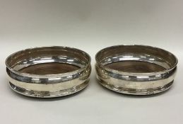 A good pair of silver wine coasters with mahogany