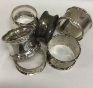 A bag containing various silver napkin rings. Appr