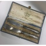 A boxed pair of silver mounted spoons. Est. £10 -