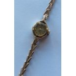 A lady's gold wristwatch. Approx. 9.3 grams. Est.