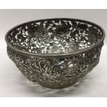 A Chinese silver bowl, the body decorated with flo